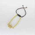 Pulsera Tejida Ajustable con Dije de Corona y Cuentas Doradas