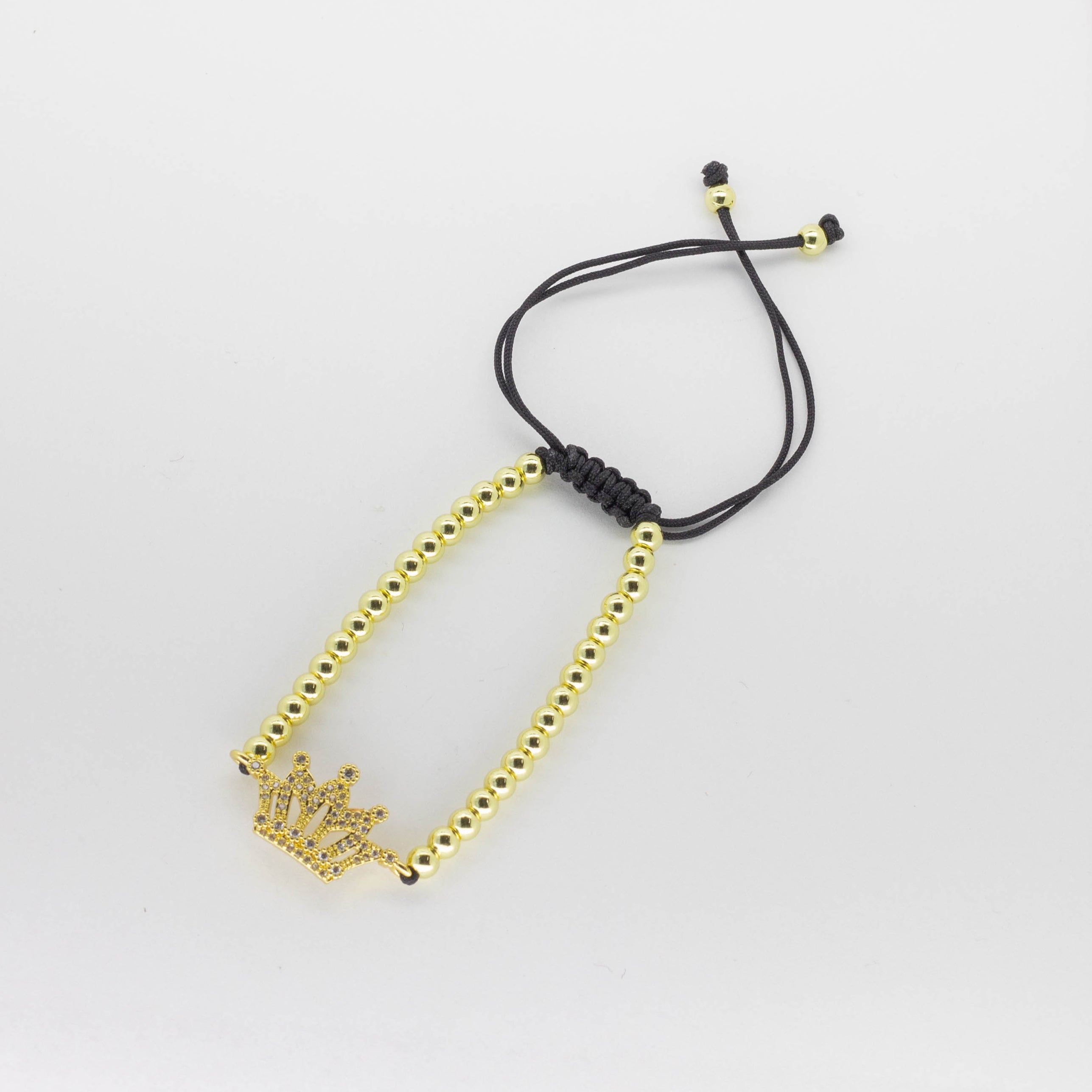 Pulsera Tejida Ajustable con Dije de Corona y Cuentas Doradas