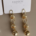 Aretes Colgantes con Nudos y Esfera
