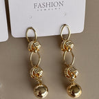 Aretes Colgantes con Nudos y Esfera