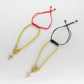 Pulsera Ajustable de Hilo con Balines Dorados, Medalla San Benito y Cruz